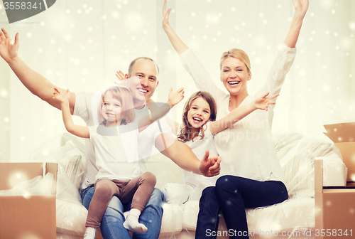 Image of smiling parents and two little girls at new home