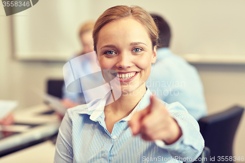 Image of smiling businesswoman pointing finger on you