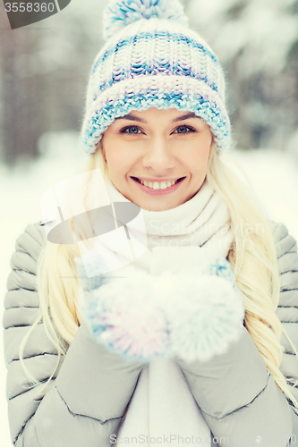 Image of smiling young woman in winter forest