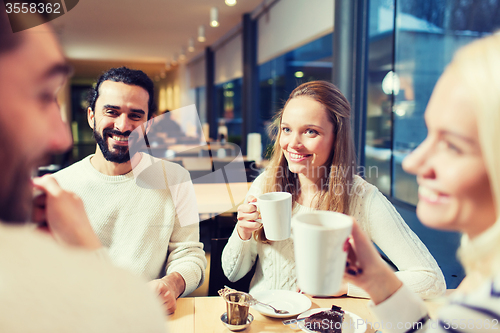 Image of happy friends meeting and drinking tea or coffee