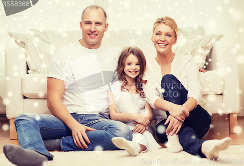 Image of smiling parents and little girl at home