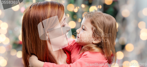 Image of happy mother and little daughter hugging