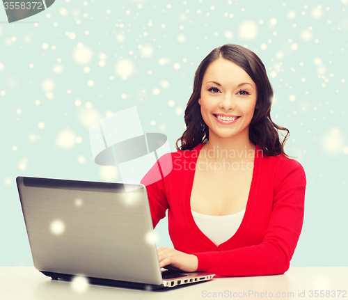 Image of smiling woman in red clothes with laptop computer