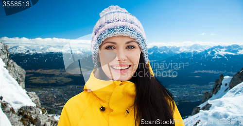 Image of happy young woman in winter clothes outdoors