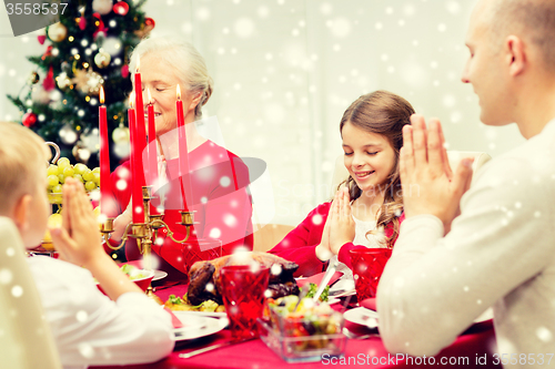 Image of smiling family having holiday dinner at home