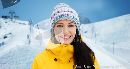 Image of happy young woman in winter clothes outdoors