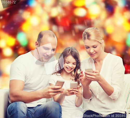 Image of happy family with smartphones