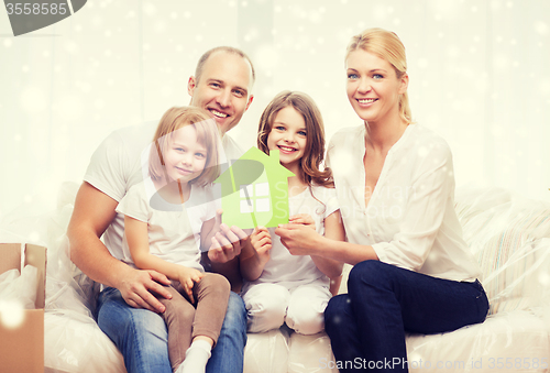 Image of smiling parents and two little girls at new home