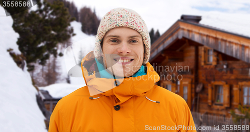 Image of happy young man in winter clothes outdoors