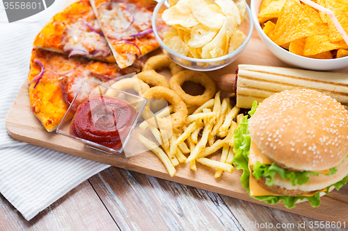 Image of close up of fast food snacks on wooden table