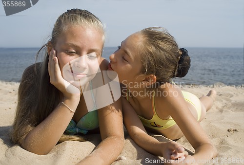 Image of Two girls play on a beach