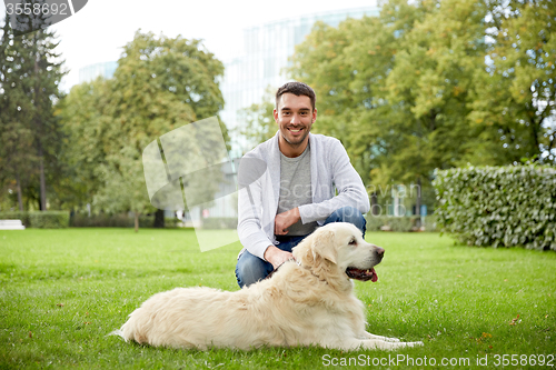 Image of happy man with labrador dog walking in city