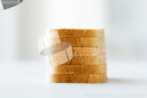 Image of close up of white sliced toast bread pile on table