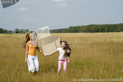 Image of Girls plays on a meadow II