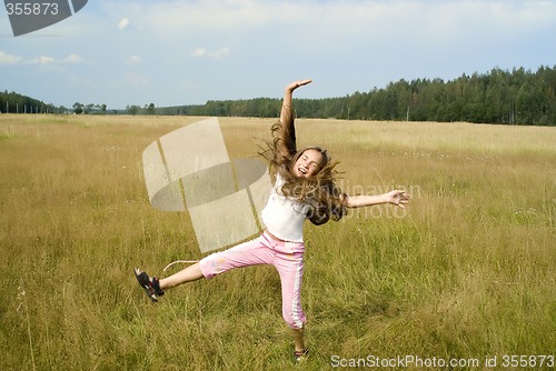 Image of Girl plays on a meadow