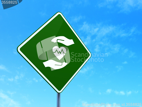 Image of Insurance concept: Heart And Palm on road sign background