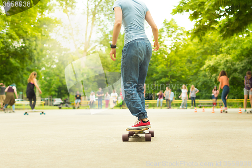 Image of Teenage girl practicing riding long board.