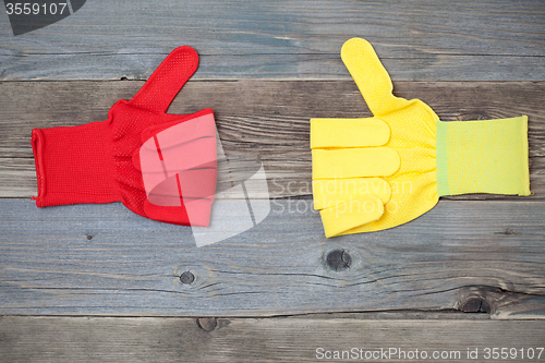 Image of two gloves with raised thumb up