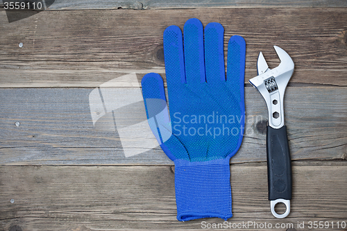 Image of Blue construction glove and wrench