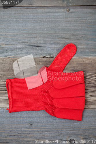 Image of gloves with raised thumb up