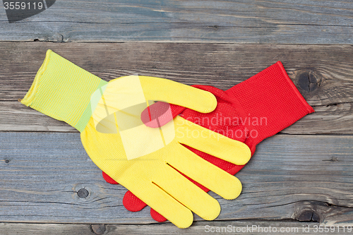 Image of handshake red and yellow construction gloves