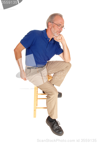 Image of Old man sitting on chair thinking.