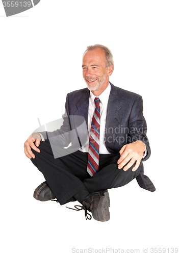 Image of Middle age mal sitting on floor.