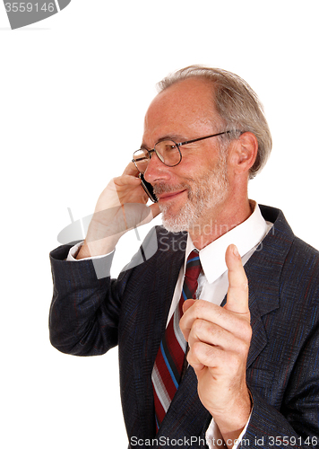 Image of Happy businessman on cell phone.