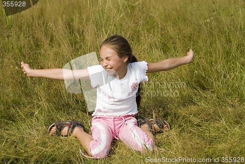 Image of Girl plays on a meadow III