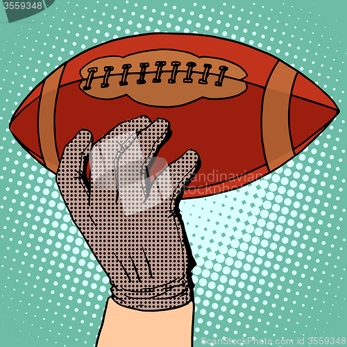 Image of The ball of American football in his hand