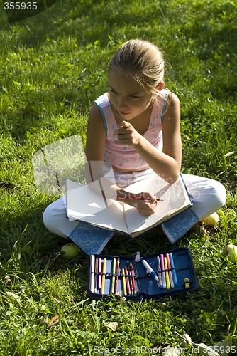 Image of The girl draws on a meadow V