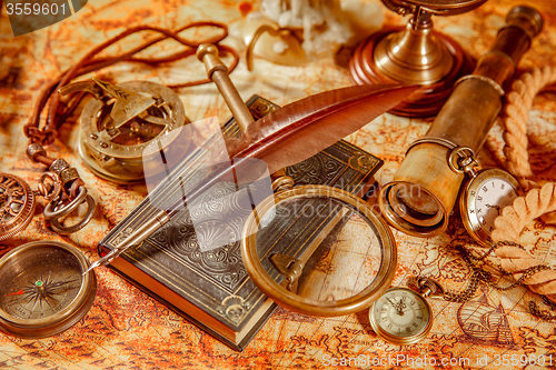 Image of Vintage magnifying glass lies on an ancient world map