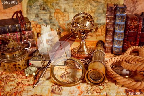 Image of Vintage magnifying glass lies on an ancient world map