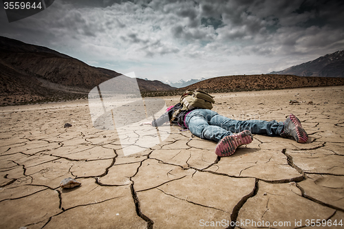 Image of Person lays on the dried ground