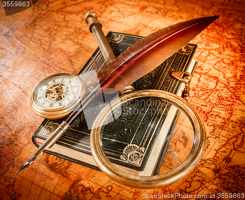 Image of Vintage magnifying glass lies on an ancient world map