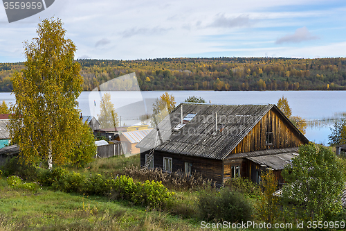 Image of Old peasant house on the shore of forest lake