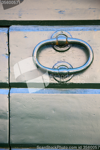 Image of  tradate abstract   rusty  brown knocker   curch  closed  lombar