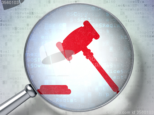 Image of Law concept: Gavel with optical glass on digital background