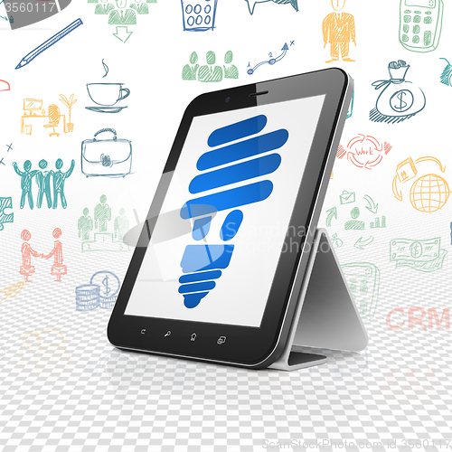 Image of Business concept: Tablet Computer with Energy Saving Lamp on display