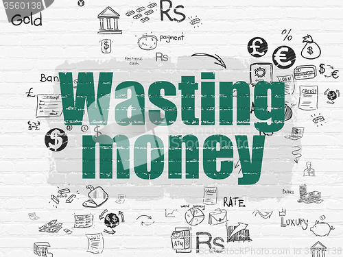 Image of Money concept: Wasting Money on wall background