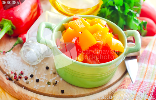 Image of Color peppers on the wooden board, pepper and knife