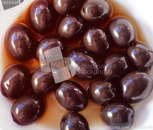 Image of Black olives on the white plate