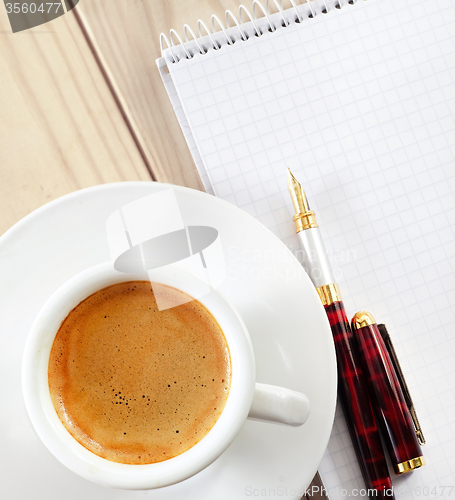 Image of Coffee in the white cup and note