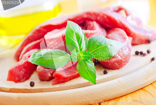 Image of raw meat on the wooden board