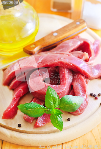 Image of raw meat on the wooden board