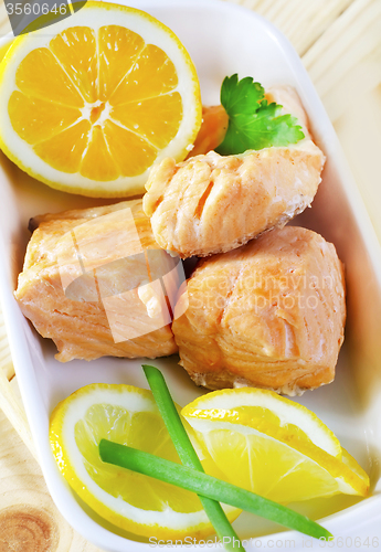 Image of Baked salmon with lemon on the white plate