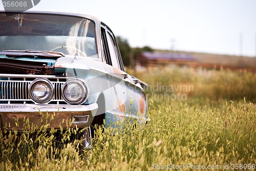 Image of abandoned car in field