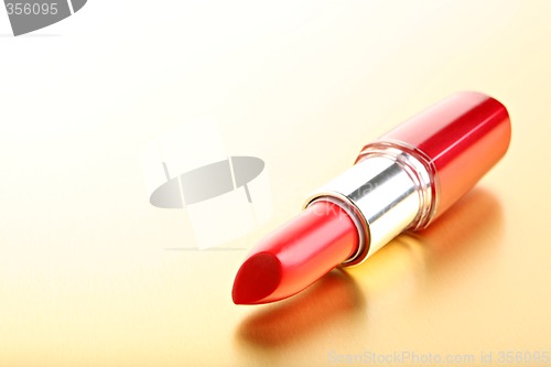 Image of lipstick closeup golden background