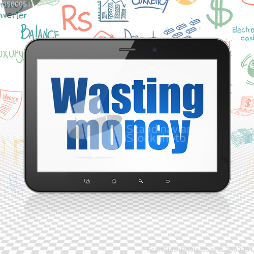 Image of Banking concept: Tablet Computer with Wasting Money on display