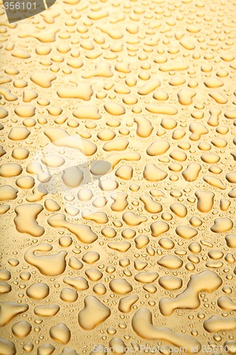 Image of water droplets gold background